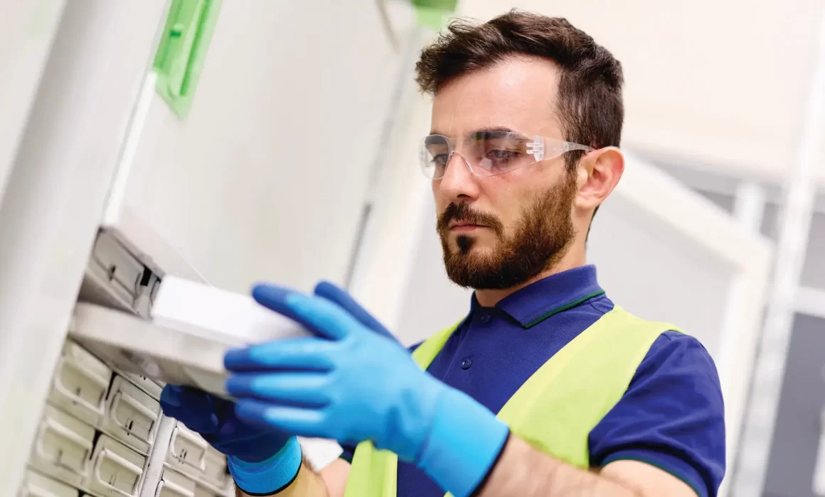 worker placing a tray in the freezer
